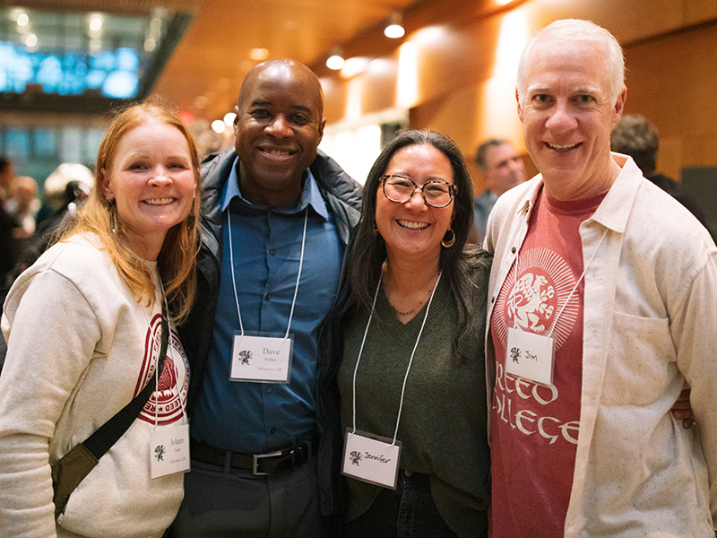 Four parents join together for a picture during Parent and Family Weekend.