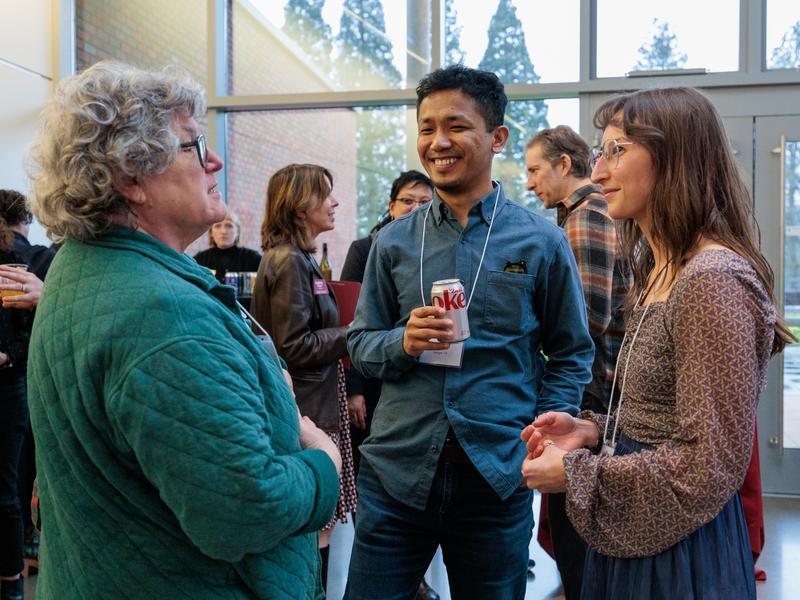Three Reed College alums chat with each other at a Reed on the Road event.