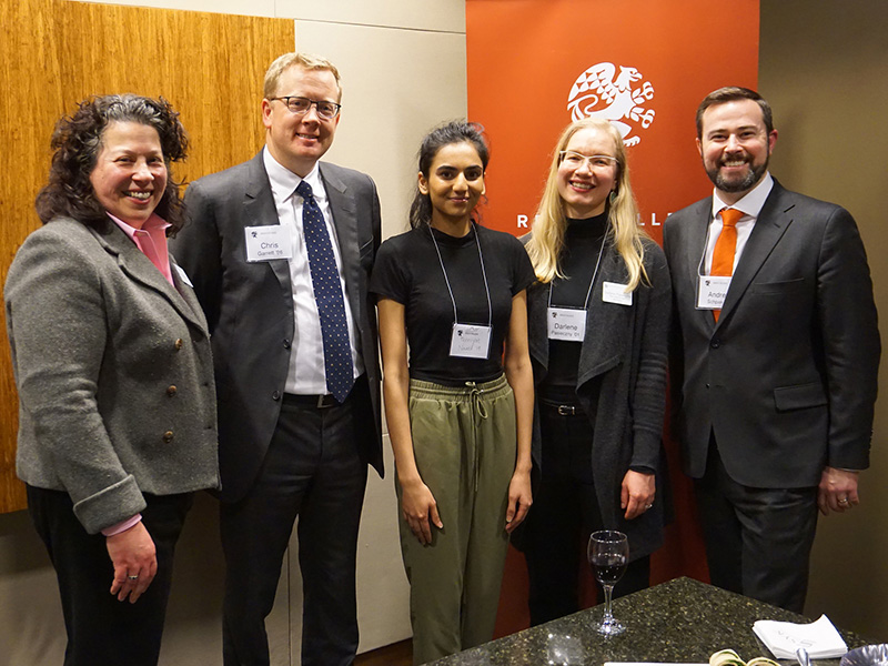 A group of Reed alumni at a legal network event smile at the camera.