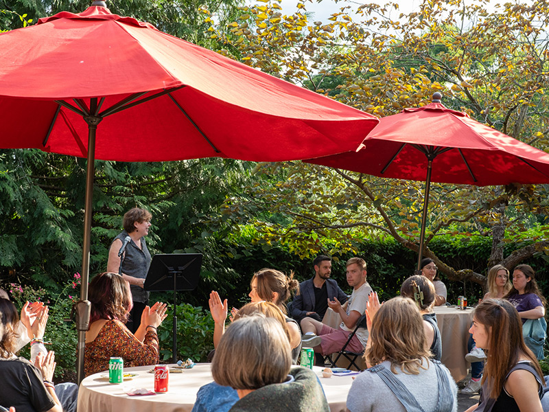 Several parents applaud a speaker at a reception at the Parker House.