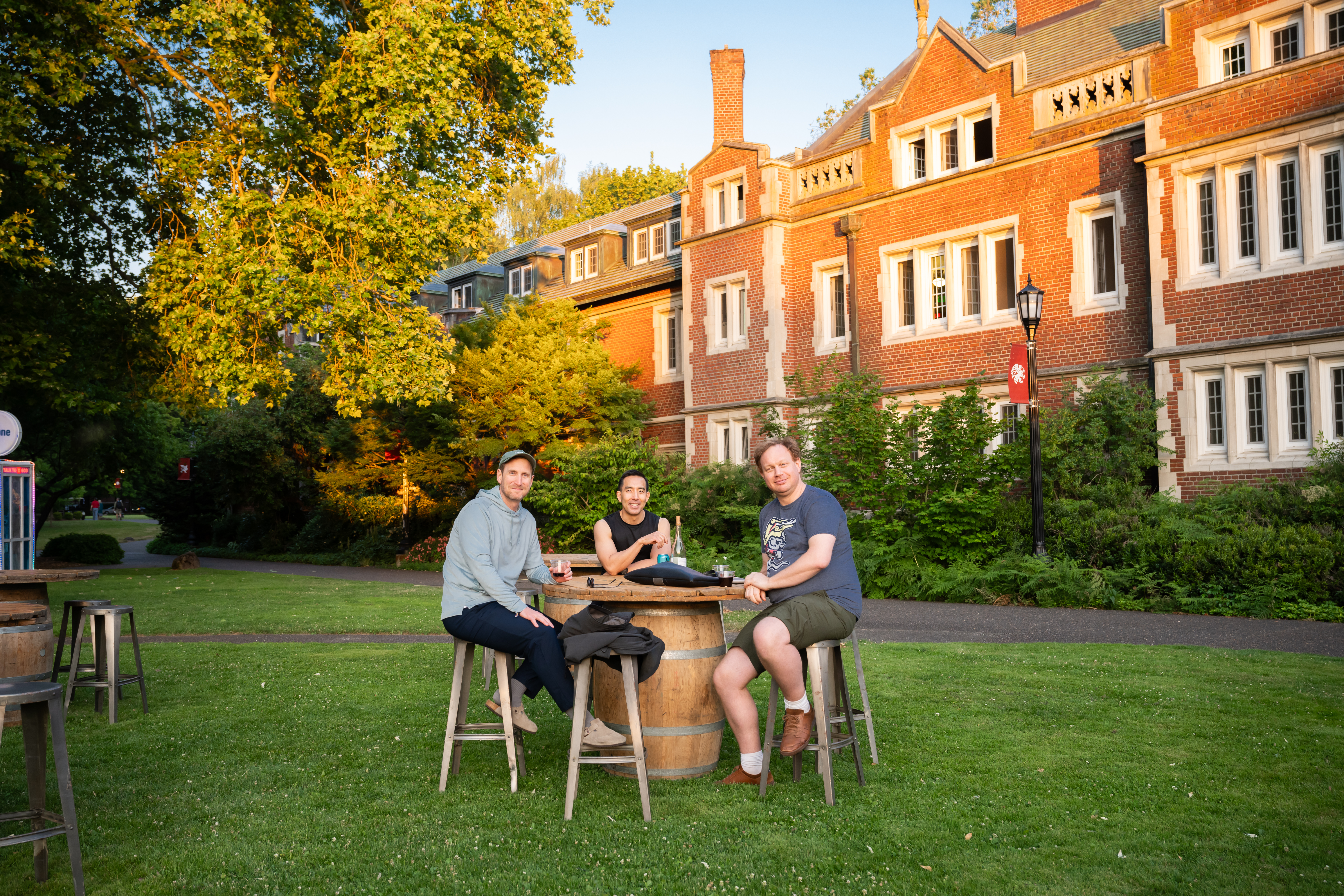 Reedies sitting at a barrel table in the quad