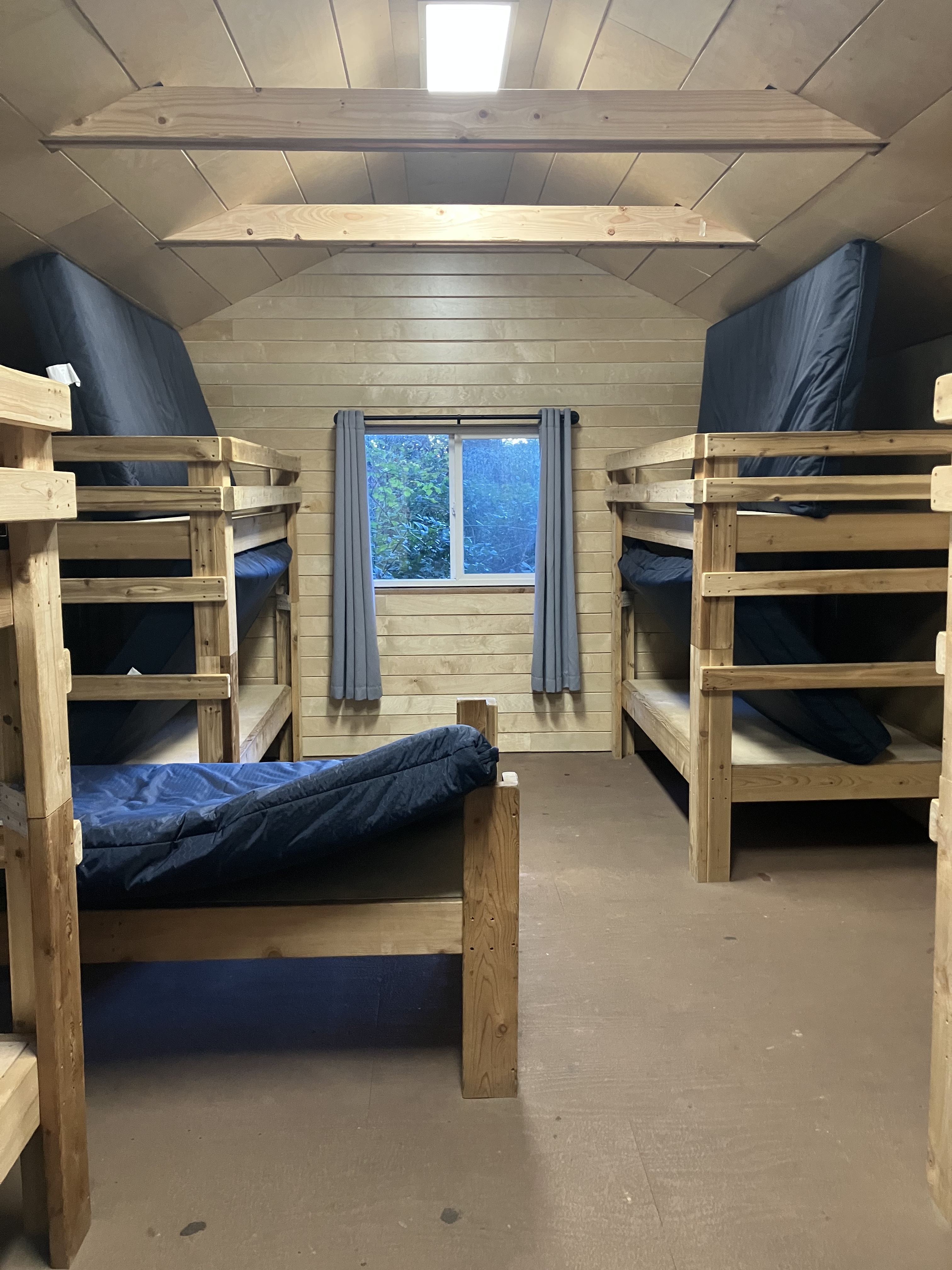 Image of a dorm with several bunkbeds